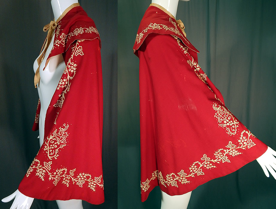 Victorian Red Wool White Embroidered Grape Vine Leaf Winter Cloak Cape
This radiant red winter cloak cape is mid length, has a layered embroidered shawl collar, ecru beige silk ribbon tie closure at the neck and is fully lined in a white cotton fabric inside. 