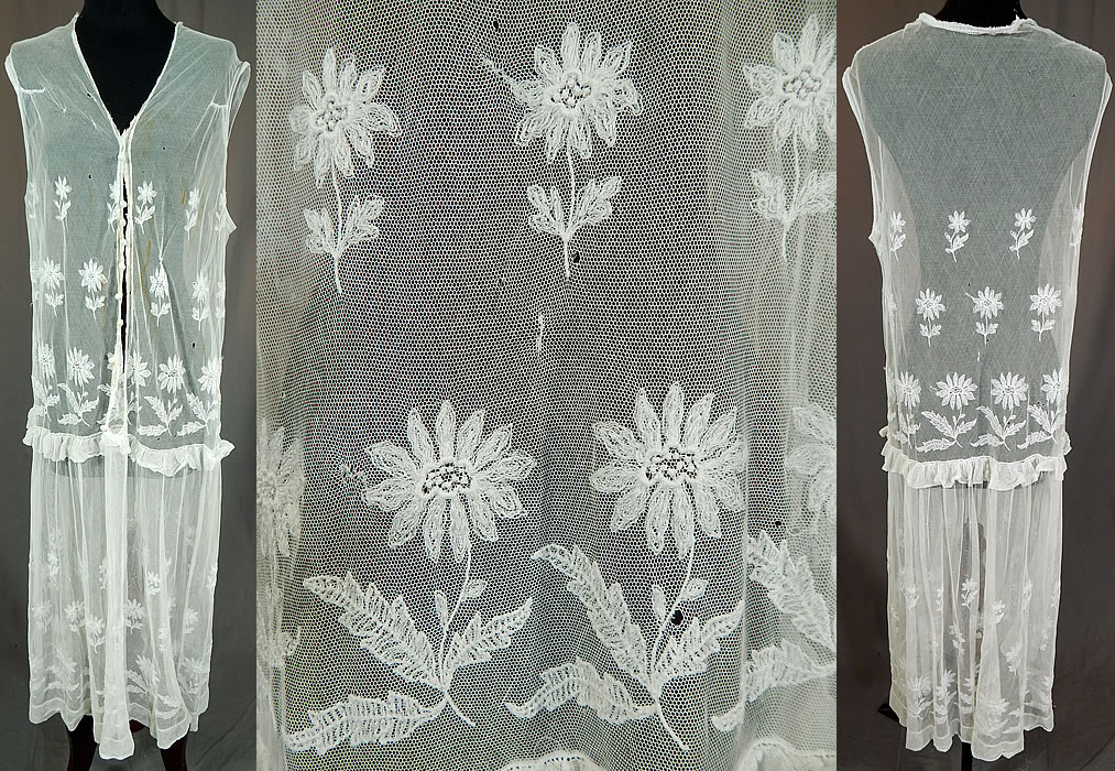 Vintage White Tulle Net Tambour Embroidery Lace Daisy Drop Waist Dress
This vintage white tulle net tambour embroidery lace daisy drop waist dress dates from the 1920s. It is made of a white sheer tulle net tambour embroidery lace fabric with an embroidered daisy flower pattern design.