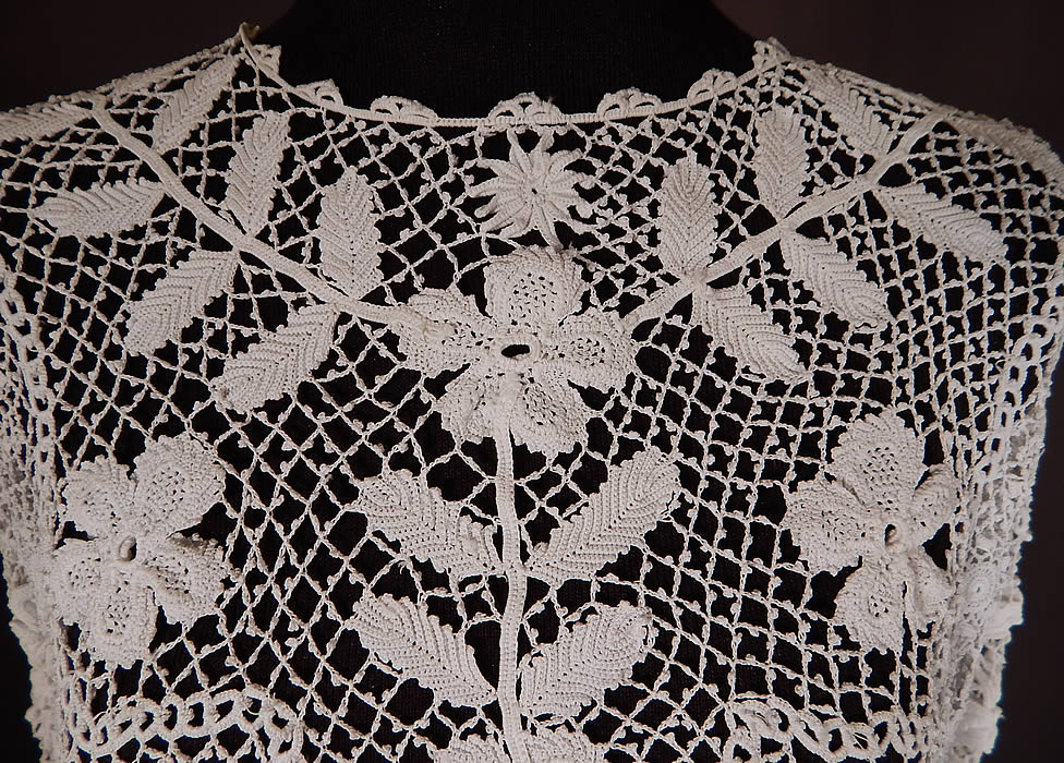 Edwardian Antique White Floral Meshwork Irish Crochet Lace Blouse
This lovely lace ladies shirt blouse top has a short crop top loose fitting style, a rounded scalloped trim neckline, long sleeves, snap closures down the back and is sheer, unlined. 