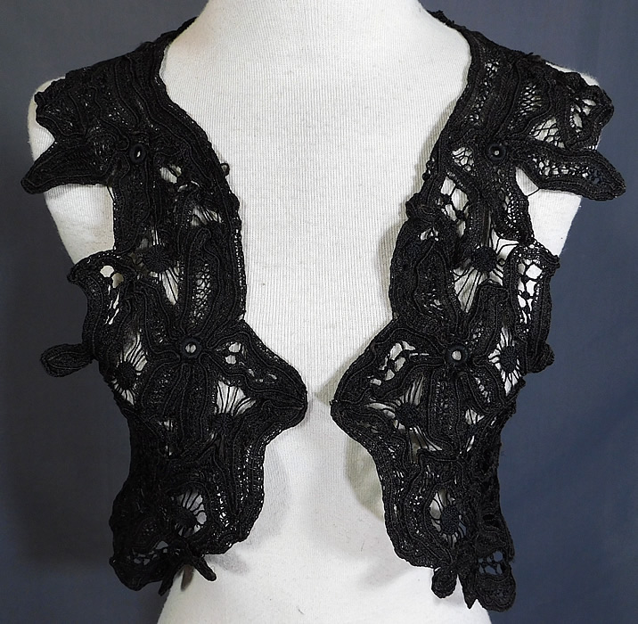 Victorian Antique Black Battenburg Lace Short Sleeveless Vest Crop Bolero Jacket
This lovely lace sleeveless vest style short crop top shrug bolero jacket has a cut away scalloped open front with no closure and is sheer, unlined.