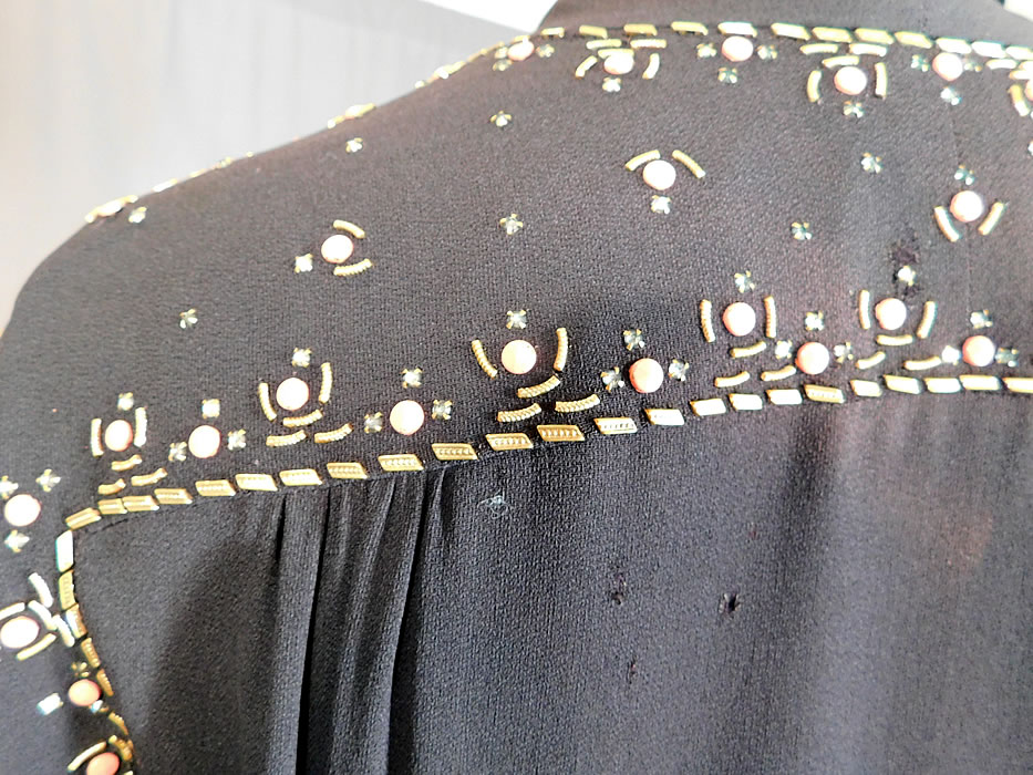 Vintage Black Silk Charmeuse Gold Studded Coral Rhinestone Beaded Cocktail Dress
It is in good as-is condition, with a three tiny pin holes and a small faded discoloration spot on the back top (see close-ups). 