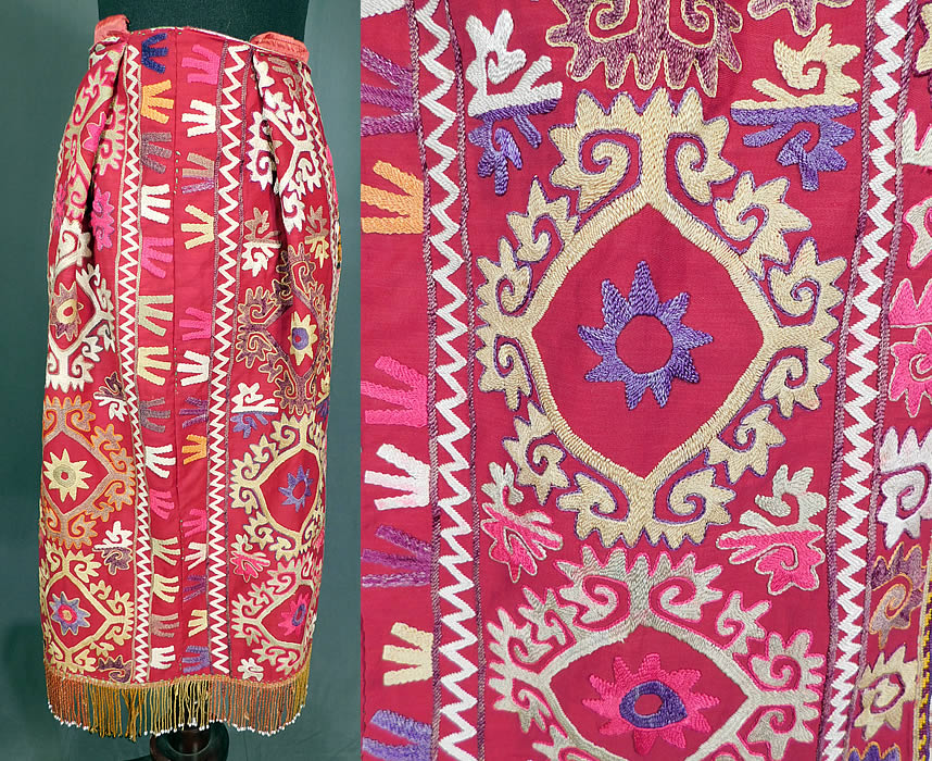 Vintage Antique Uzbekistan Suzani Embroidered Tribal Textile Half Apron Skirt
This vintage antique Uzbekistan Suzani embroidered tribal textile half apron skirt dates from the early 20th century. It is made of a red cotton fabric, with colorful hand embroidered Suzani style ethnic tribal designs and an ombre rope trim beaded fringe along the bottom hem. Suzanis were traditionally made by Central Asian brides as part of their dowry. 