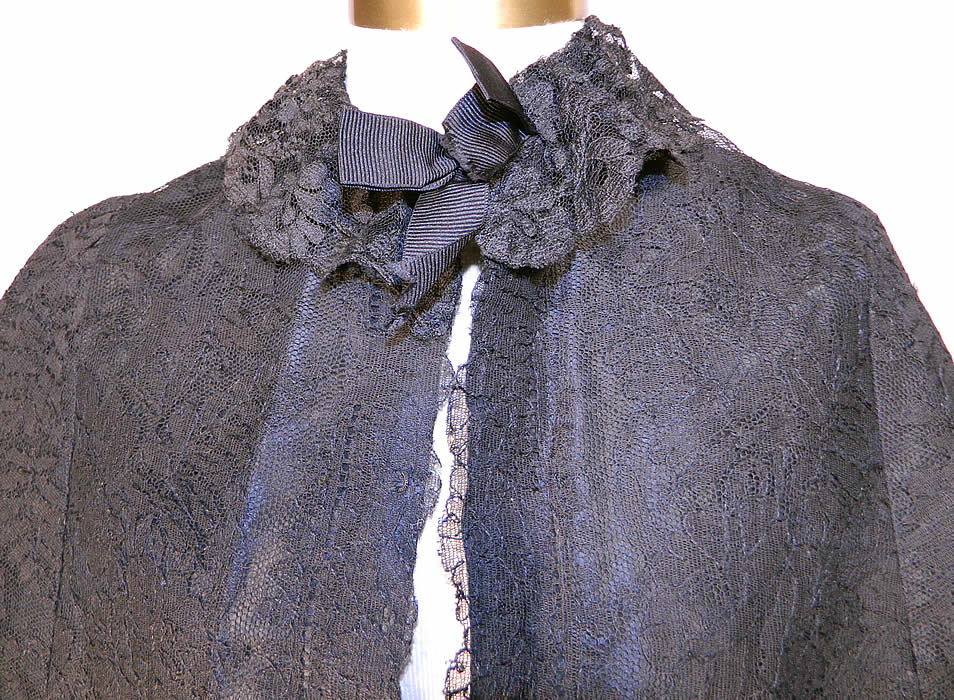 Victorian Black Chantilly Lace Mourning Mantle Cape Dolman Capelet. . This magnificent mourning mantle dolman style cape capelet has a black lace silk ribbon bow trim ruffle collar, a fitted back bottom skirt drape, hooks for closure down the front and is fully lined in a black silk taffeta fabric inside. 