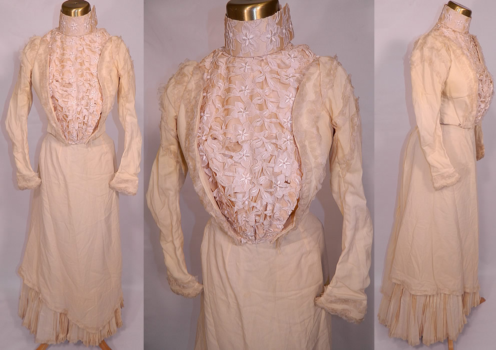 Victorian Cream Wool Lace Applique Bustle Bridal Wedding Gown Dress. This antique Victorian era cream wool applique lace bustle bridal wedding gown dress dates from the 1880s. It is made of an off white cream color soft fine wool fabric, with a cream chiffon ruffle trim edging, silk front insert panel, with white silk embroidered floral cutwork lace applique trim overlay and collar. 