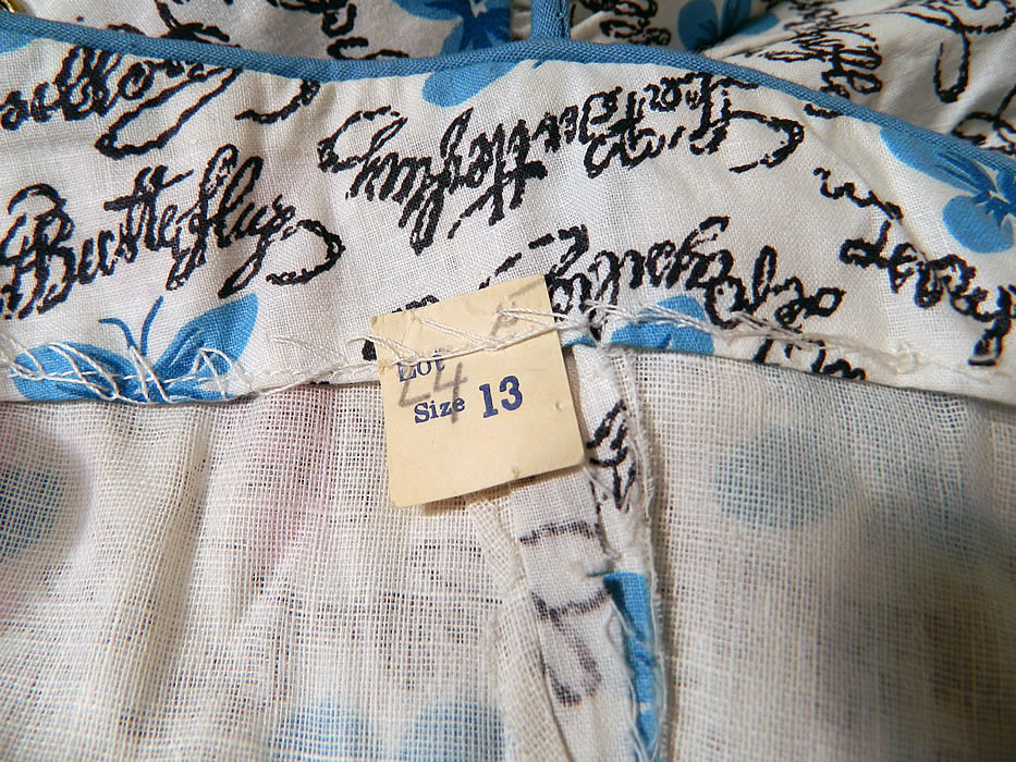 Vintage Blue Butterfly Papillon Print Cotton Circle Skirt Summer Sun Dress. There is a size 13 tag sewn inside. The dress measures 46 inches long, with  a 28 inch waist and 34 inch bust.