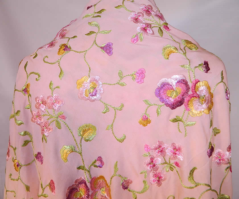 Vintage Pastel Pink Silk Floral Pansy Embroidered  Flapper Boho Piano Shawl. There is matching pink hand knotted silk fringe which measures 17 inches long surrounding the entire shawl. The shawls fabric square measures 52 by 52 inches.