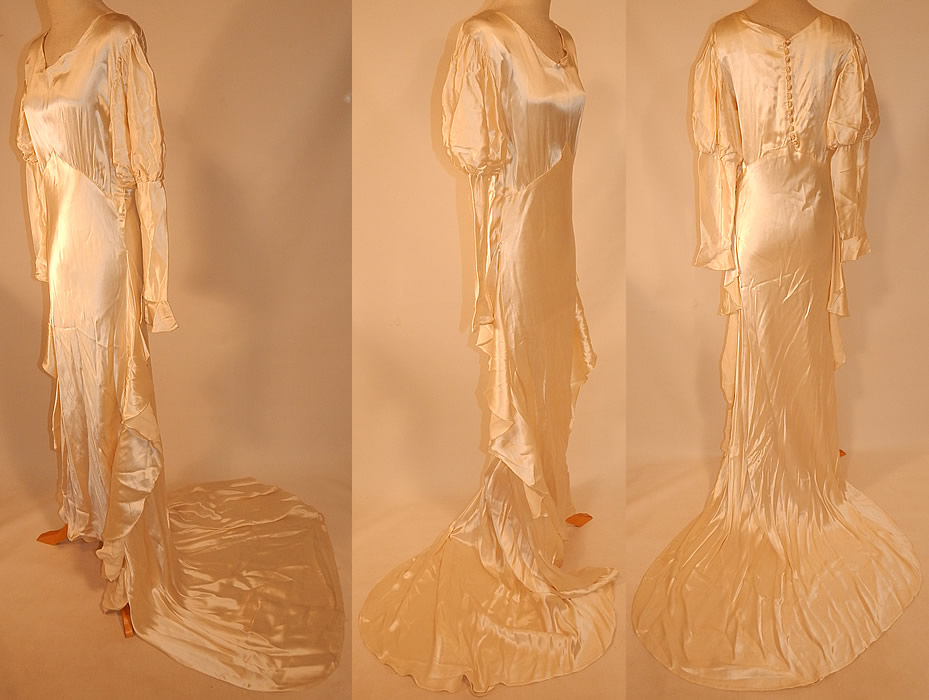 Vintage White Silk Satin Bias Cut Wedding Gown Dress Long Train Skirt
The dress measures 57 inches long in the front, 80 inches long in the back with train, 40 inch hips, a 30 inch waist, 36 inch bust and 19 inch long sleeves.