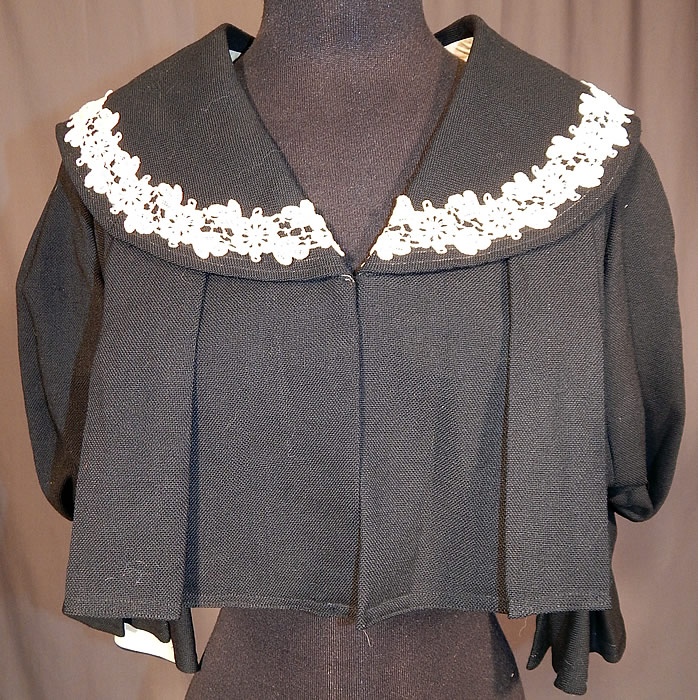 Victorian Box Pleat Black Wool White Lace Bolero Spencer Jacket Cropped Top
This antique Victorian era box pleat black wool white lace bolero spencer jacket cropped top dates from 1900. It is made of a box pleat fine black wool fabric, with white lace trim edging around the collar. 