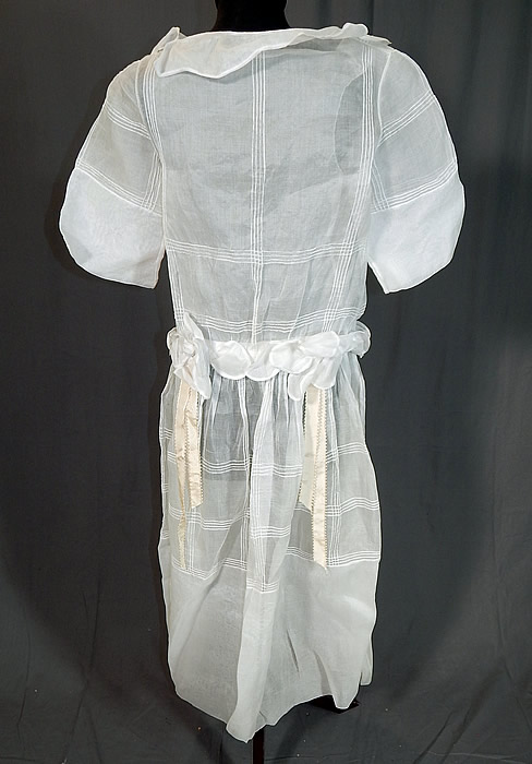 Vintage Windowpane White Organdy Rosette Ribbon Trim Drop Waist Dress
The dress measures 48 inches long, with a 32 inch waist and 38 inch bust. It is in excellent condition, with only a faint small age spot stain on the rosette flower sash (see close-up). This is truly a wonderful piece of wearable art which could be worn as a bridal wedding dress!