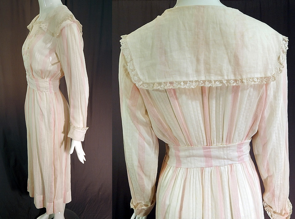 Edwardian White Cotton Pink Stripe Sailor Collar Middy Top Tea Dress
his pretty pink striped tea length dress has a middy top style with a white wide sailor collar, lace trim edging, mother of pearl button trim accents on the front bib top, long sleeves with rolled lace trim cuffs, a fitted waist, front side snap closures and is sheer, unlined.