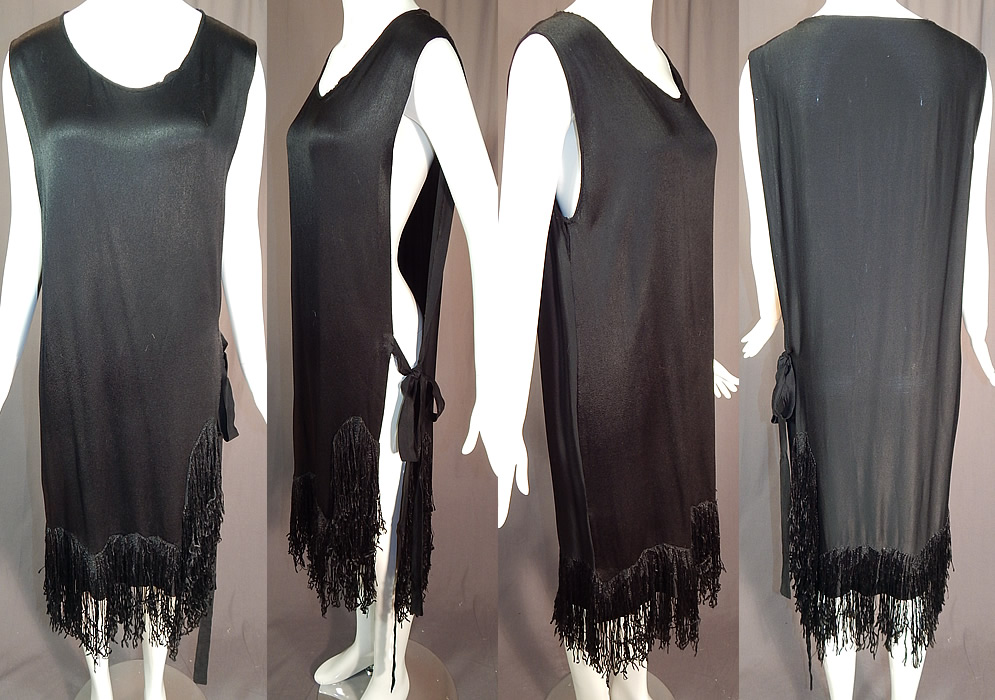 Vintage Black Silk Crepe de Chine Knotted Fringe Flapper Tabard Tunic Dress
This vintage black silk crepe de chine knotted fringe flapper tabard tunic dress dates from the 1920s. It is made of a black silk crepe de chine fabric with a hand embroidered knotted black silk fringe trim edging the bottom skirt. This fabulous fringed flapper dress has a tabard tunic straight shift style with an open side, tie sash closure, sleeveless, loose fitting and is unlined. 
