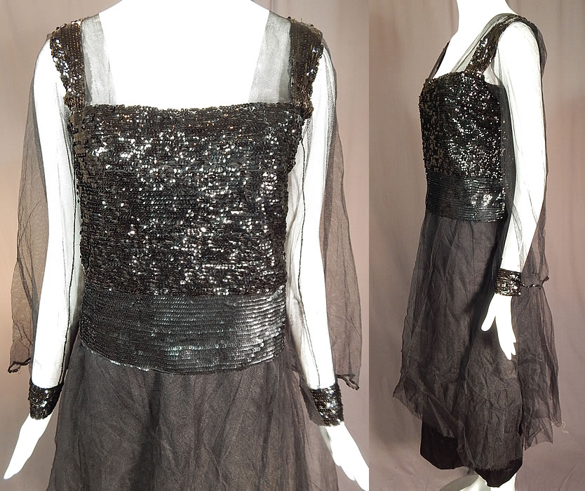 Vintage Art Deco Black Silk Tulle Net Sequin Beaded Evening Gown Flapper Dress
This fabulous flapper dress evening gown is a tea length, with a squared neckline, long sheer tulle net sleeves which flare out with sequin trim fitted cuffs, a sequin beaded sash, layered tiered skirt, is fully lined and has hook closures down the back. 