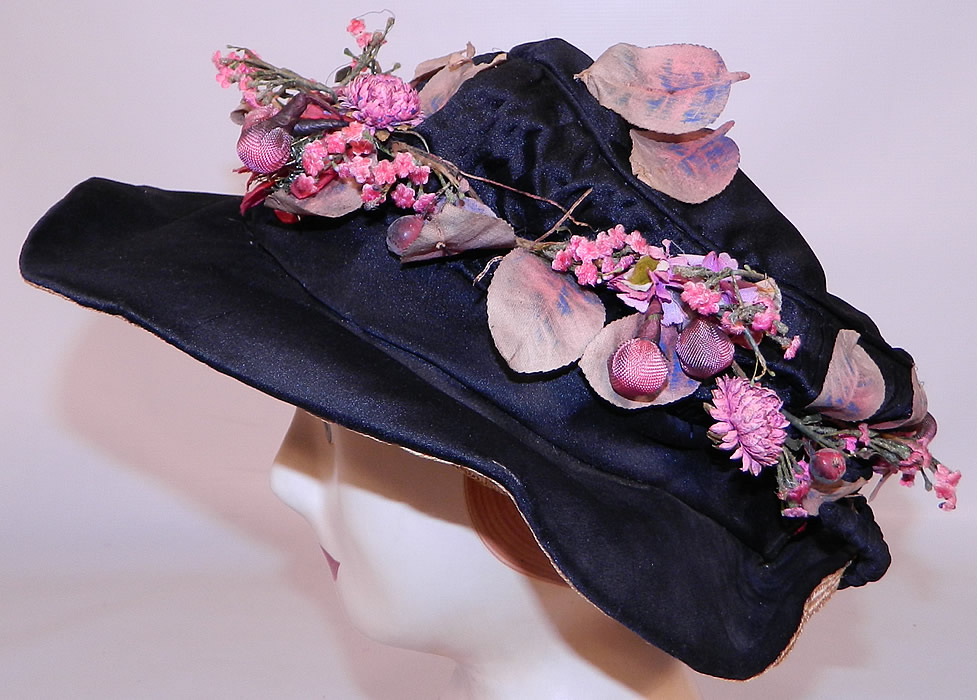 Edwardian Black Silk & Natural Straw Floral Garland Trim Wide Brim Hat. This beautiful hat has an uneven wavy brim, wider in the front, narrow in back and slouched soft round crown top. 