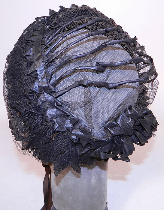Victorian Civil War Era Black Net Ribbon Trim Mourning Bonnet Snood Headdress. This antique Victorian Civil War era black net ribbon trim mourning bonnet snood headdress dates from the 1860s.