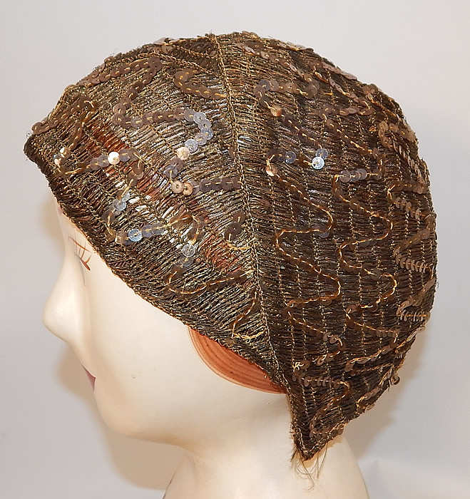 Vintage Smart Hat Label Art Deco Gold Lamé Lame Woven Sequin Beaded Flapper Cloche
The hat measures 22 inches inside circumference. It is in good condition, with only a few missing sequins and some fraying along the edging. This is truly a wonderful piece of wearable Art Deco millinery art!