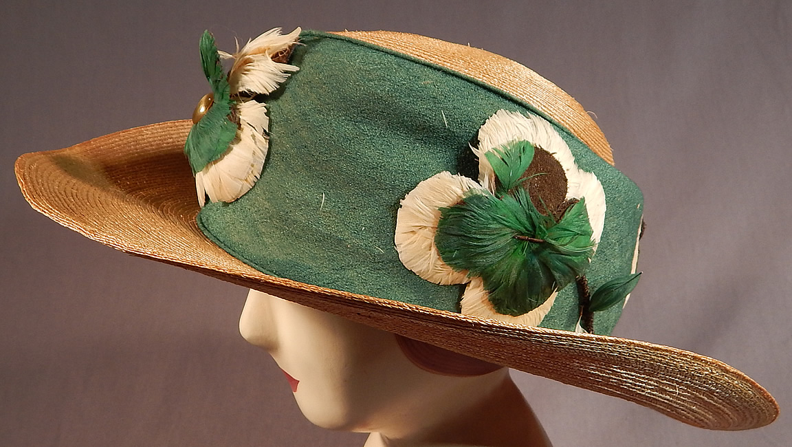 Vintage M. H. Loach Natural Woven Straw Green Ribbon Feather Rosette Wide Brim Hat
The hat is made of a woven natural straw with a green silk ribbon wide hatband trim, green and white feather rosette flower appliquéd trim with gold metallic wrapped wire stems attached around the crown. 