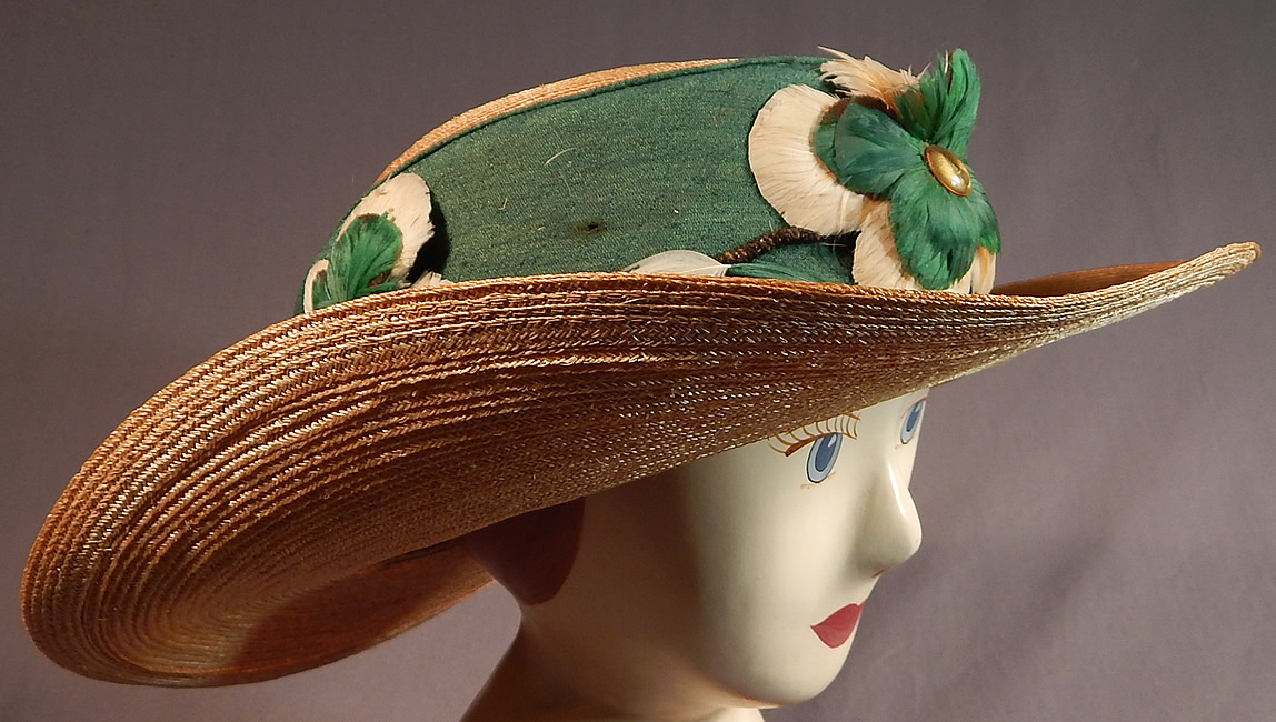 Vintage M. H. Loach Natural Woven Straw Green Ribbon Feather Rosette Wide Brim Hat
This Edwardian era vintage M. H. Loach natural woven straw green ribbon feather rosette wide brim hat dates from the 1910.