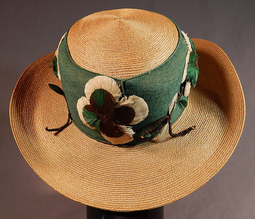 Vintage M. H. Loach Natural Woven Straw Green Ribbon Feather Rosette Wide Brim Hat
The hat measures 22 1/2 inches inside crown circumference, 44 inches outside and is 14 inches across the brim.