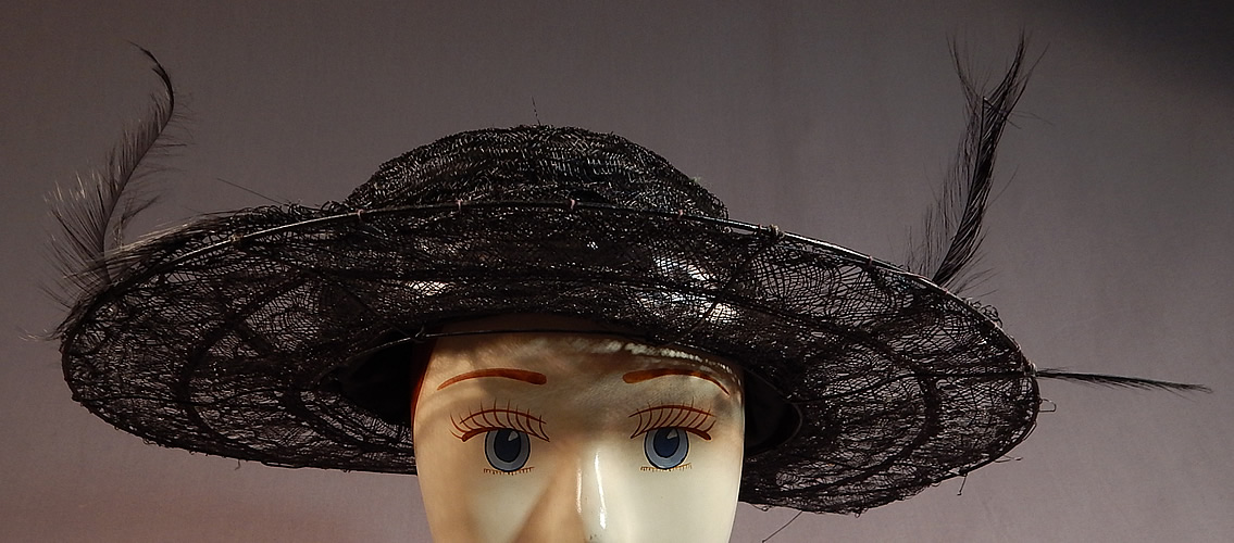 Edwardian Black Woven Horse Hair Crinoline Feather Trim Wired Wide Brim Hat
It is made of a black sheer woven stiffened horse hair crinoline covering a wired brim with black feather plume trim accents and a black silk lustrous ribbon hatband surrounding the crown.
