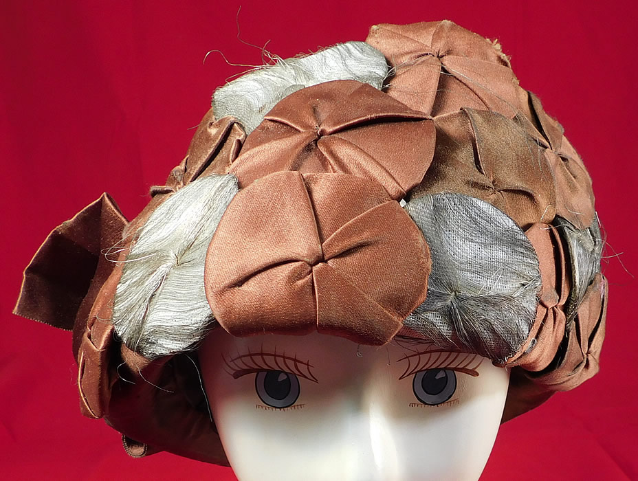 Vintage Fashion Hat Art Deco Brown Silk Silver Lame Rosette Flapper Cloche
The hat is made of a golden brown color silk fabric, with brown silk and silver metallic lame overlapping rosettes covering the front.