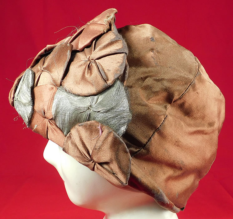 Vintage Fashion Hat Art Deco Brown Silk Silver Lame Rosette Flapper Cloche
This vintage Fashion Hat Art Deco brown silk silver lame rosette flapper cloche dates from the 1920s.