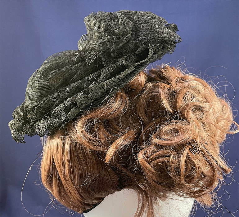 Victorian Antique Black Chantilly Tambour Lace Net Wire Frame Morning Bonnet Hat
This antique Victorian era black Chantilly tambour lace net wire frame morning bonnet hat dates from the 1860s. It is made of an oval shaped wired frame covered with a sheer fine black net tambour lace with chain stitch embroidery flowers and black Chantilly lace scalloped trim edging. 