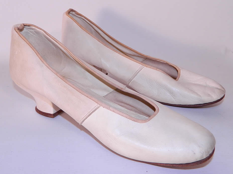 Victorian White Kid Leather Small Bridal Wedding Slippers Shoes Straight Sole. They are made of a soft supple white kid leather. These beautiful bridal slipper shoes have a slip on style, rounded toes, leather straight soles, with no left or right distinction and a 1 1/2 inch high kid covered Louis XV French heel. 