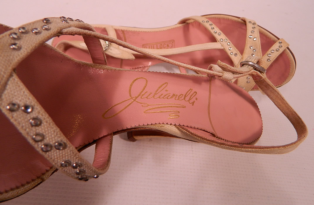 Vintage Julianelli White Linen Rhinestone Strap Sling Back Sandal Shoes. They have a pink insole lining with a gold embossed label inside "Julianelli", "Bullock's Wilshire" and are stamped a size 7 N. 