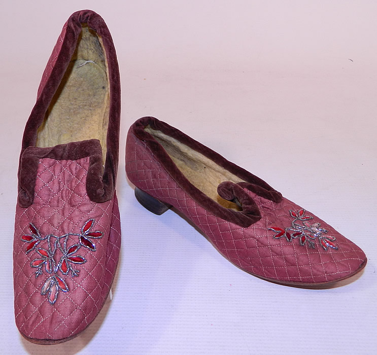Victorian Burgundy Quilted Silk Steel Cut Beaded Velvet Trim Slipper Shoes
This pair of antique Victorian era burgundy quilted silk steel cut beaded velvet trim slipper shoes date from 1890. 