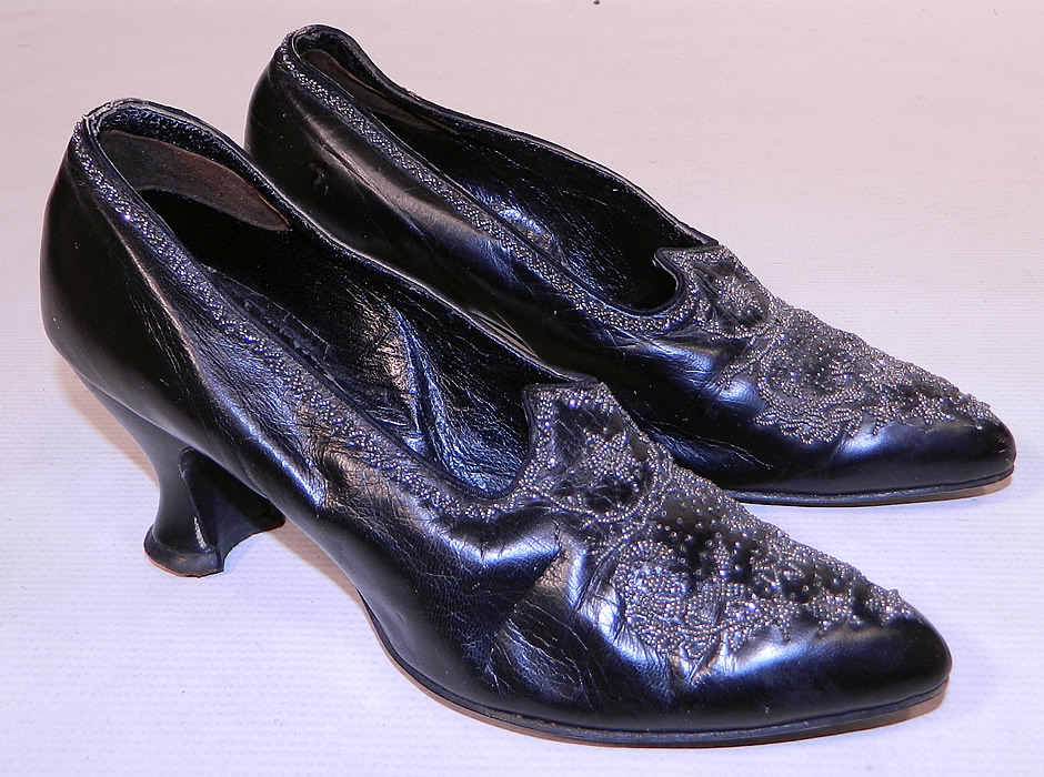 Victorian Black Leather Steel Cut Beaded Trim Patriotic Stars Shoes
This pair of antique Victorian era black leather silver steel cut beaded trim patriotic stars shoes date from 1900. They are made of black leather, with silver steel cut beading done in a patriotic star, shield, laurel wreath pattern design on the front toes and decorative beading going around the top sides.