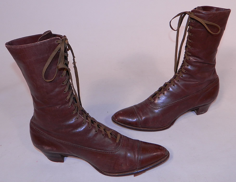 Victorian Antique Womens Brown Leather High Top Lace-up Boots Shoes
This pair of antique Victorian era womens brown leather high top lace-up boots shoes date from 1900. They are made of a brown leather, with decorative punch work designs along the bottom shoe and on the toes. 