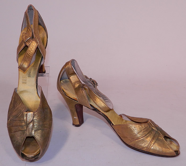 Vintage E.T. Slatter Co. Boston Label Gold Leather Ankle Strap Evening Dance Shoes
This pair of vintage E.T. Slatter Company Boston label gold leather ankle strap evening dance shoes date from the 1930s. They are made of a gold metallic lamé leather.