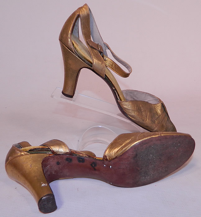 Vintage E.T. Slatter Co. Boston Label Gold Leather Ankle Strap Evening Dance Shoes
The shoes measure 10 inches long, 2 1/2 inches wide, with 3 inch high heels and are approximately a size 6 or 7 narrow width. They are in good condition and have been gently worn, with some gold worn off the leather in areas with some slight discoloration. These are truly a wonderful piece of wearable Art Deco shoe art!