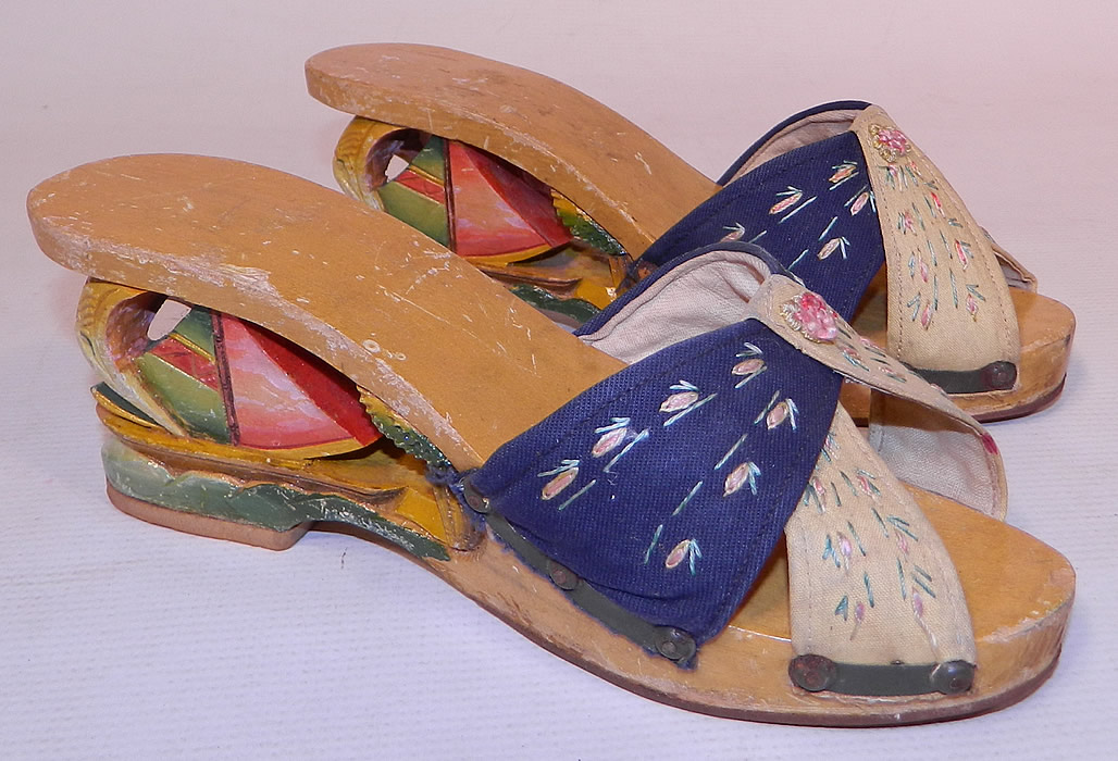 Vintage Philippines Hand Painted Carved Wooden Wedge Sailboat Mules Sandal Shoes
These stunning sandal shoes have a backless mule slip on slipper style, open toes, a platform front and wedge heels. After the war, American GIs returned home from the Philippines with these shoes as gifts for their girlfriends and wives.
