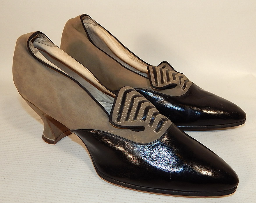 Vintage La Parisienne France Art Deco Gray Suede Black Leather Flapper Shoes
This pair of vintage La Parisienne France Art Deco gray suede black leather flapper shoes date from the 1920s. They are made of a supple grayish brown taupe color soft suede leather and black patent leather front toe, with a decorative cutout Art Deco design on the front instep vamps tongues.