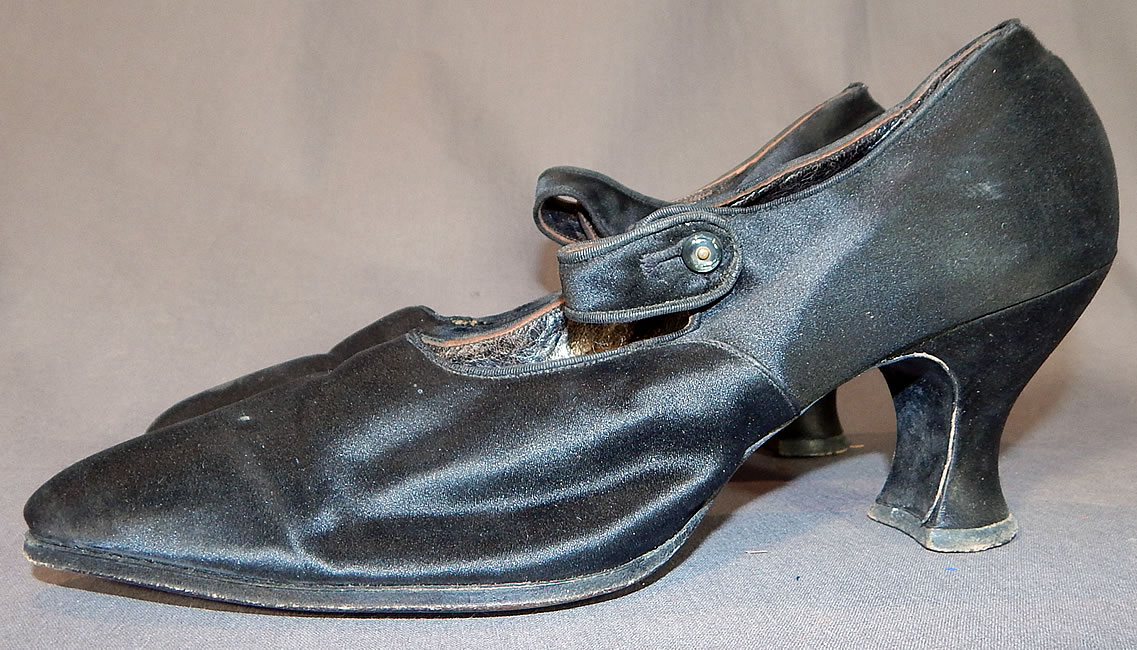 Edwardian Black Silk Satin Button Strap Mary Jane Pointed Toe Shoes
The shoes measure 10 inches long, 2 1/2 inches wide, with a 2 inch high heel. They are approximately a size 6 or 7 narrow width.