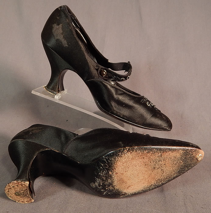 Edwardian Vintage Gundlach's Black Silk Beaded Button Strap Mary Jane Shoes
These womens Mary Jane style shoes have a beaded button strap closure across the front instep, decorative floral beading on the vamps, pointed toes and silk covered French Louis XV spool heels. 