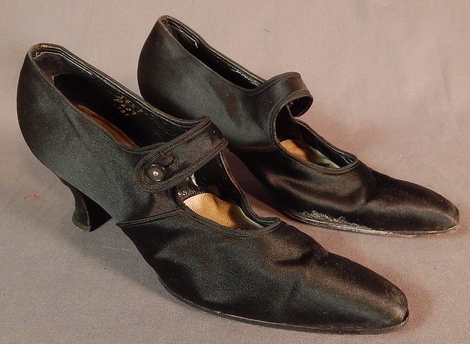 Edwardian Vintage Sommer and Kaufmann Black Silk Button Strap Mary Jane Shoes
They are made of a black silk satin fabric. These womens Mary Jane style shoes have a button strap closure across the front instep vamps, pointed toes and silk covered French Louis XV spool heels. 