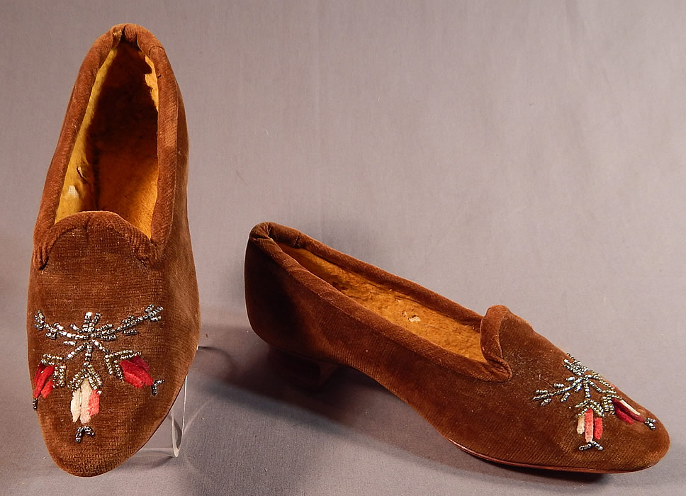 Victorian Brown Velvet Chenille Embroidered Steel Cut Beaded Slipper Shoes
These beautiful brown womens shoes have a slip on slipper style, with a scalloped tongue instep vamp, rounded toes, 1 inch high stacked wooden low French Louis XV heel and are fully lined in a yellow soft cotton batting flannel fabric inside.