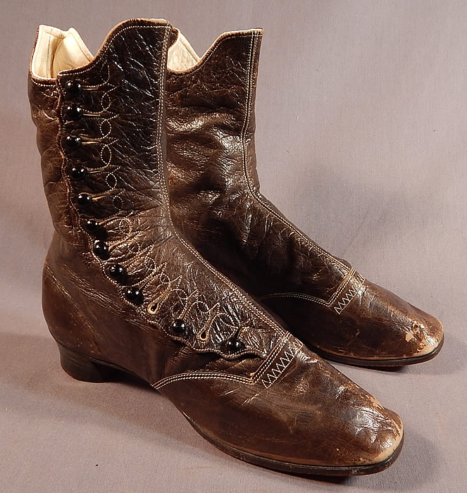 Victorian Brown Leather White Stitching Scalloped High Top Button Boots Shoes
This pair of antique Victorian Civil War era brown leather white stitching scalloped high top button boots shoes dates from the 1860s. They are made of a supple dark brown leather with decorative white stitching accents.