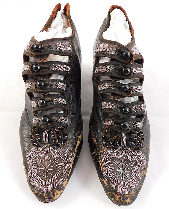 Victorian Antique Brown Leather Steel Cut Beaded 5 Button Strap Shoes
These beautiful beaded evening shoes have five black buttons cutout straps going across the front instep for closure and a black leather covered low Louis XV French heel.