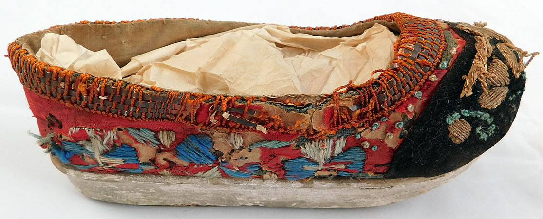 Antique 19th Century Chinese Silk Embroidered Childs Wedge Pedestal Boat Shape Shoes
They are in fair as-is condition, with frayed missing pieces of red silk fabric, loose missing embroidery work stitching and fraying along the top edging trim (see close-ups).