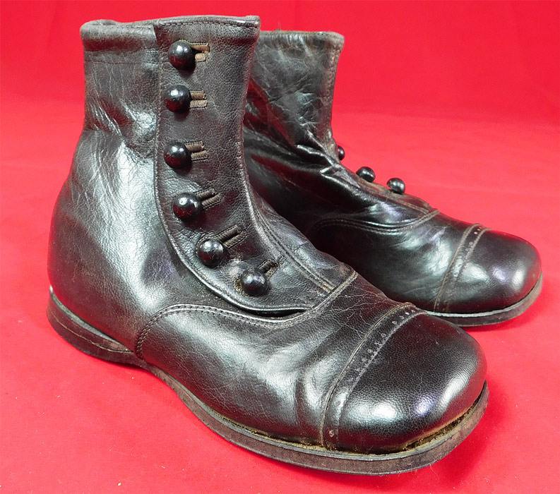 Edwardian Unworn Black Leather High Button Baby Boots Childs Shoes
This pair of antique Edwardian era unworn black leather high button baby boots child's shoes date from 1910. They are made of a black leather, with 6 black buttons down the side for closure. 