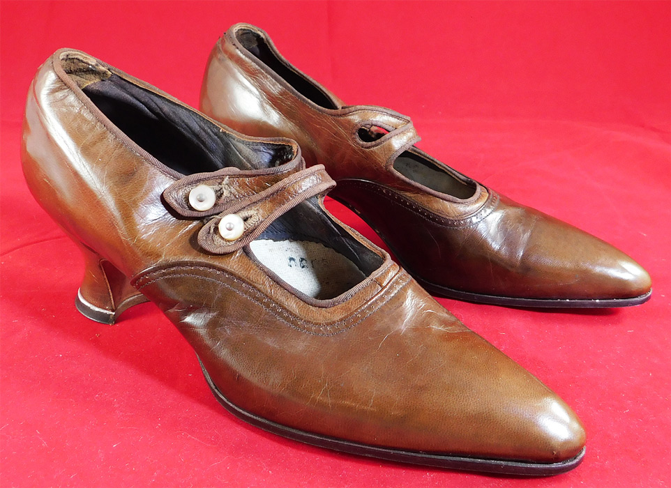 Unworn Edwardian Two Tone Tan Leather Oxford Button Strap Shoes & Box
They are made of a two tone tan brown color leather. These beautiful brown shoes are an Oxford Mary Jane style with double button strap closures, pointed toes and leather covered Louis XV French spool heels. 
