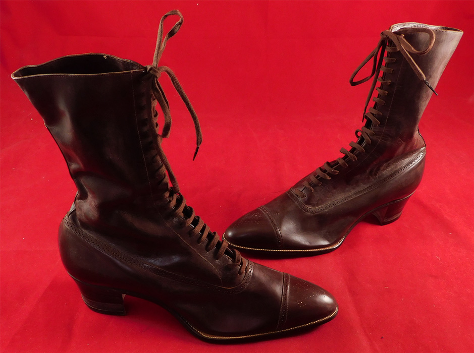 Unworn Vintage Edwardian Dark Brown Leather High Top Lace-up Boots & Box
This pair of unworn antique Edwardian era dark brown leather high top lace-up boots and shoe box date from 1910. They are made of a dark chocolate brown color leather with decorative punch work designs on the front toes and edging the shoe.