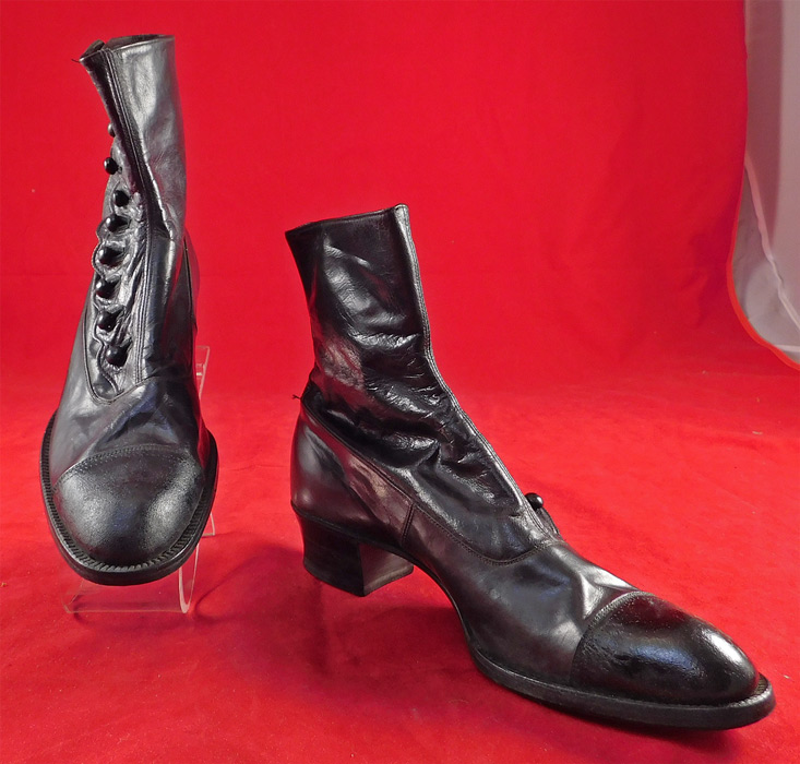 Victorian Unworn Womens Black Leather High Top Button Boots
This pair of antique Victorian era unworn womens black leather high top button boots date from 1900. They are made of a black kid leather with black patent leather front toes. 