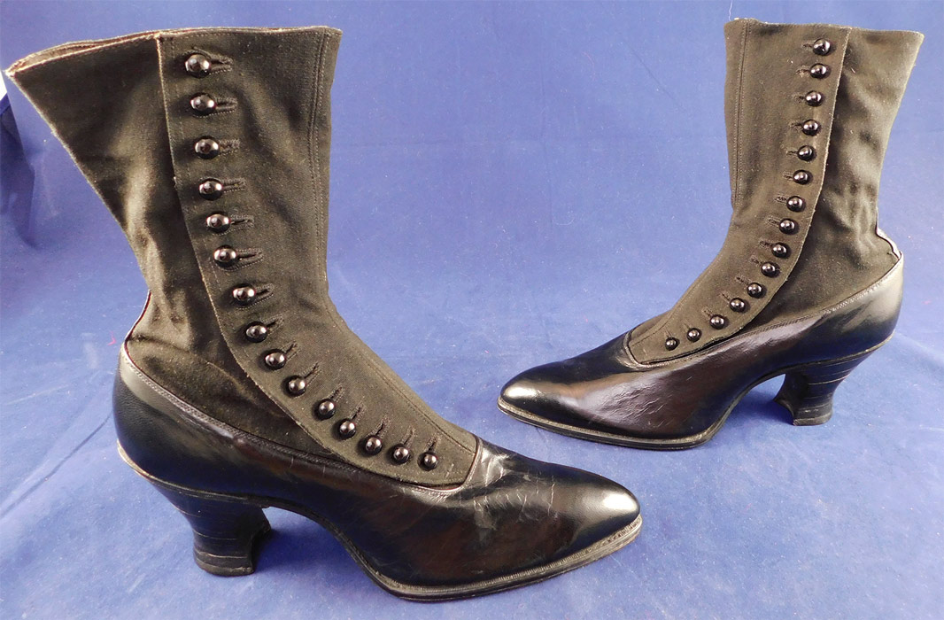 Unworn Edwardian Black Cloth Top Kid Leather Button Boots & Spiderweb Shoe Box
The boots measure 9 1/2 inches tall, 10 inches long, 2 3/4 inches wide, with a 2 1/2 inch high heel and are approximately a US size 7 narrow width.