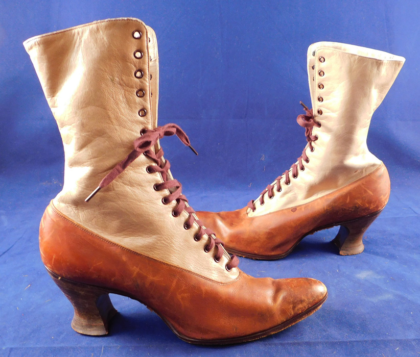 Edwardian BSWU Women's Two Tone Brown Leather High Top Lace-up Boots
This pair of antique Edwardian era BSWU women's two tone brown leather high top lace-up boots date from 1905. They are made of a two tone brown color leather with a lighter beige tan shade on the top. 