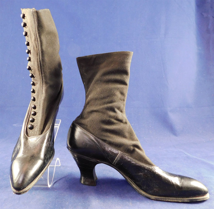Unworn Edwardian Black Cloth Top Kid Leather High Button Boots & Shoe Box
The boots measure 9 1/2 inches tall, 10 inches long, 2 3/4 inches wide, with a 2 1/2 inch high heel and are approximately a US size 7 or 8 narrow width.