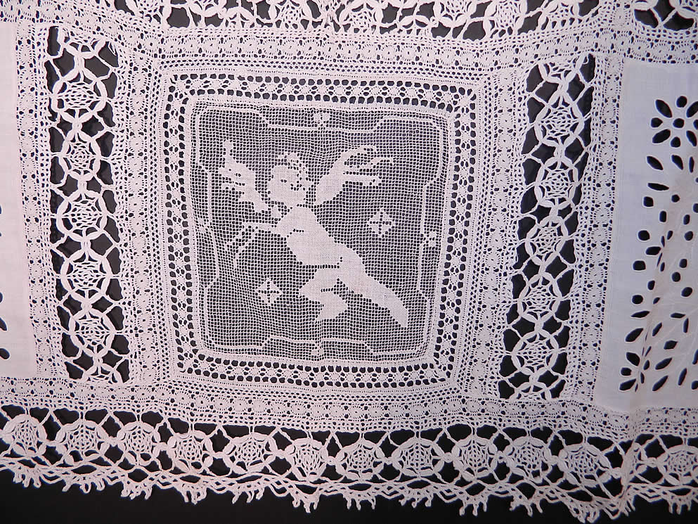 Victorian Antique Filet Bobbin Lace Renaissance Cupid Linen Cutwork Tablecloth. There is a decorative Renaissance inspired allegorical design  with cupid angels and swans done in filet lace.